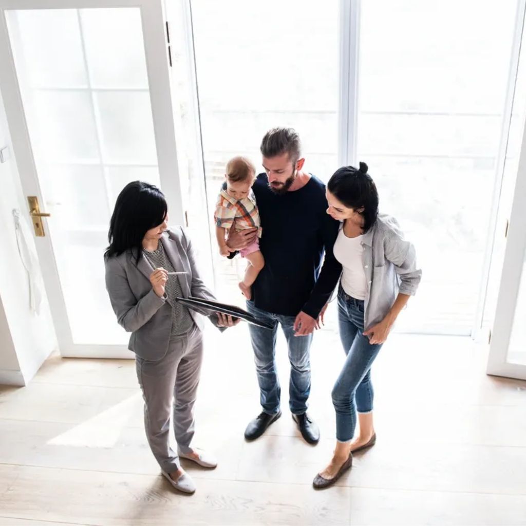 A group of people standing in front of a window.