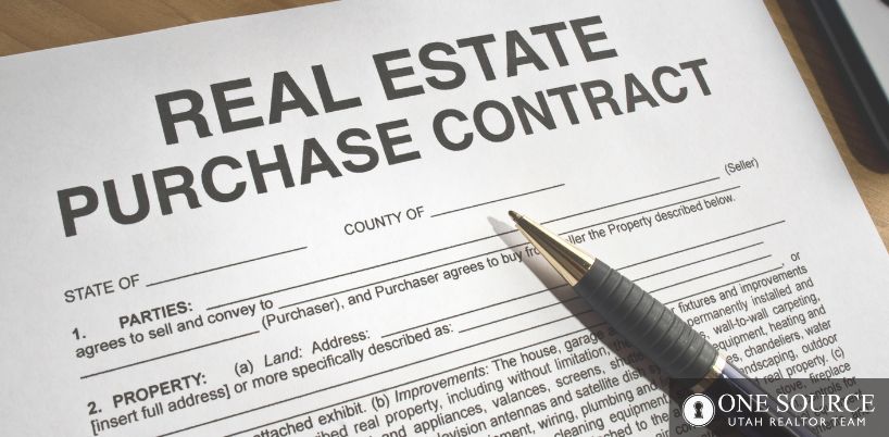 A real estate purchase contract with pen and paper