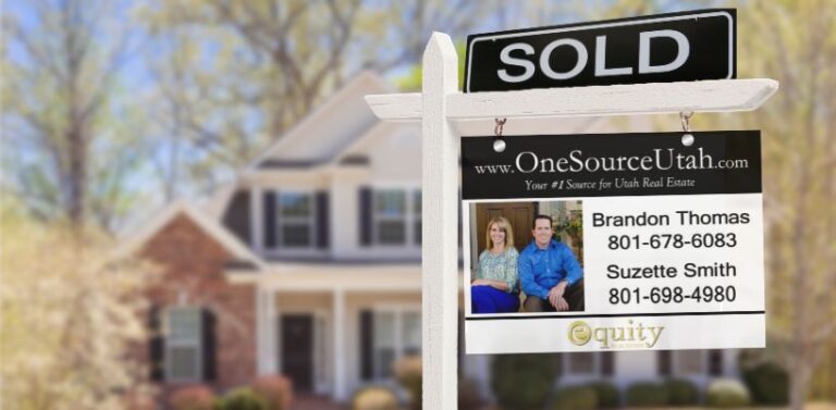 "Sold sign in front of a house."