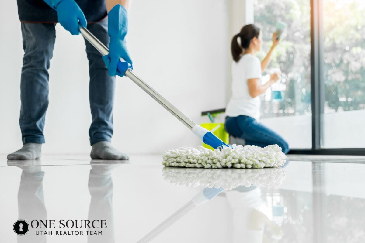 People cleaning a bright room together.